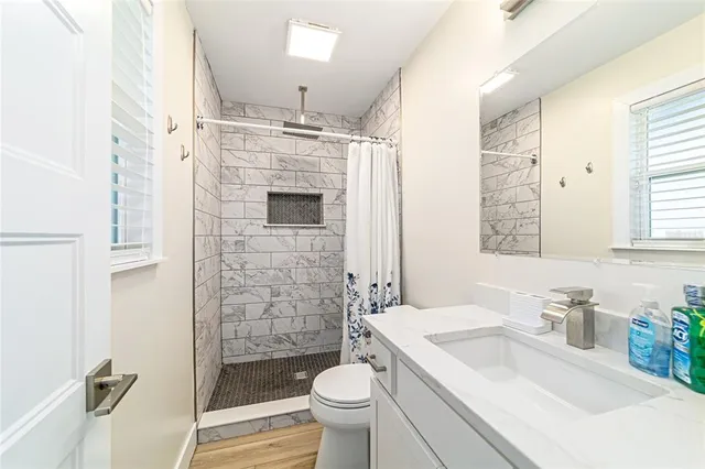 a bedroom with a large bed and a window