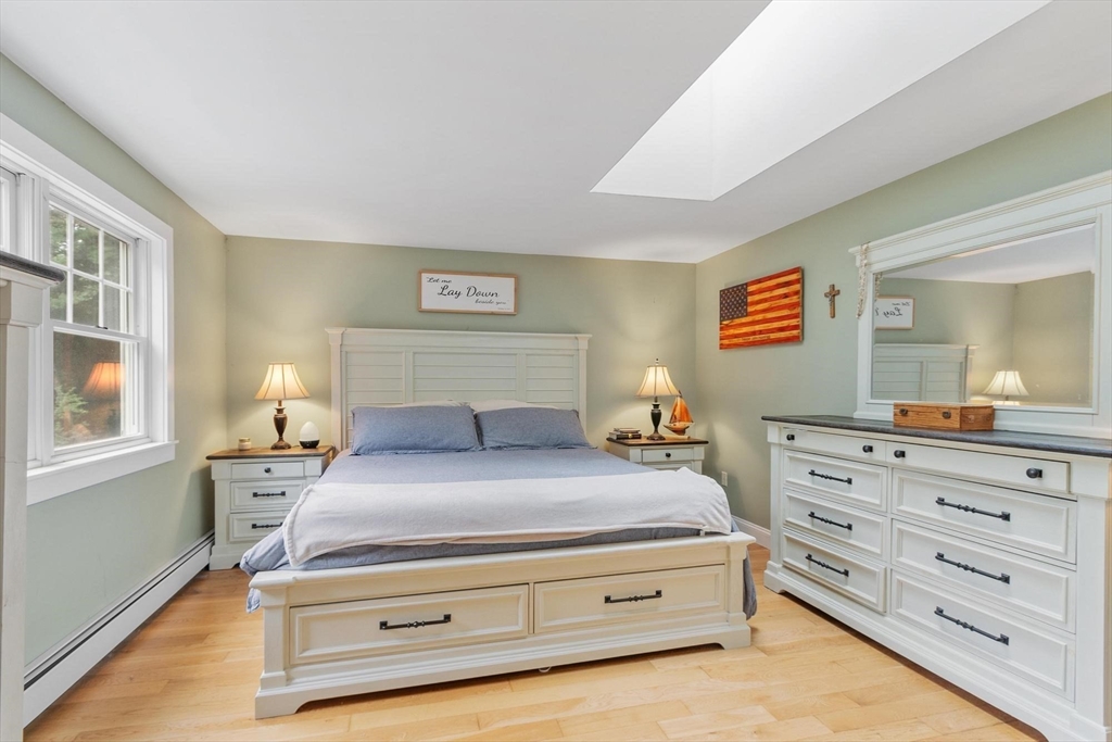 241 Reservoir Road Lunenburg, MA 01462 - Photo 7 of 40 a bedroom with a bed and a mirror on dresser