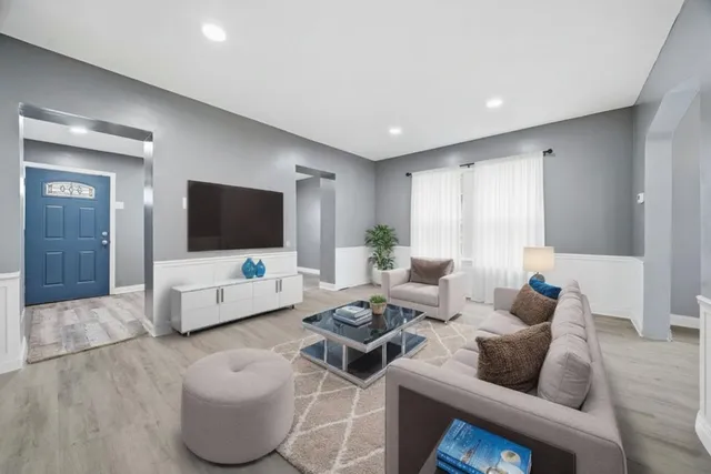 a living room with furniture and a flat screen tv