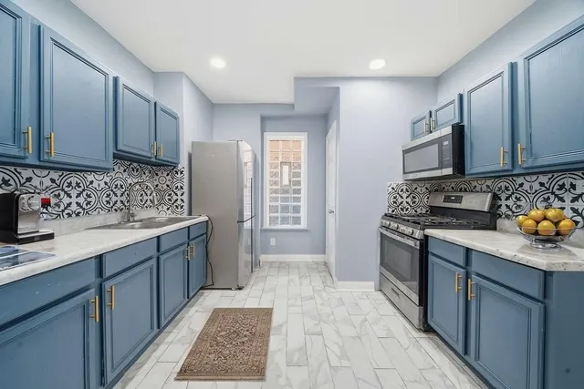 a kitchen with a sink stove and cabinets