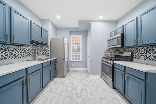 a kitchen with a sink stove and refrigerator