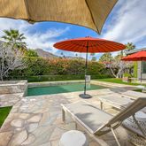 a view of a patio with a table chairs under an umbrella