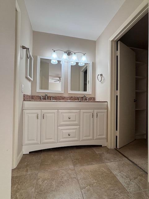 6191 Riverwalk Lane, Unit 4 Jupiter, FL 33458 - Photo 13 of 16 a bathroom with a granite countertop double vanity sink a mirror and a