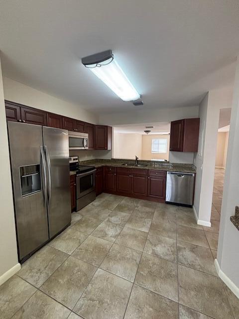 6191 Riverwalk Lane, Unit 4 Jupiter, FL 33458 - Photo 3 of 16 a large kitchen with granite countertop a refrigerator and a stove top oven