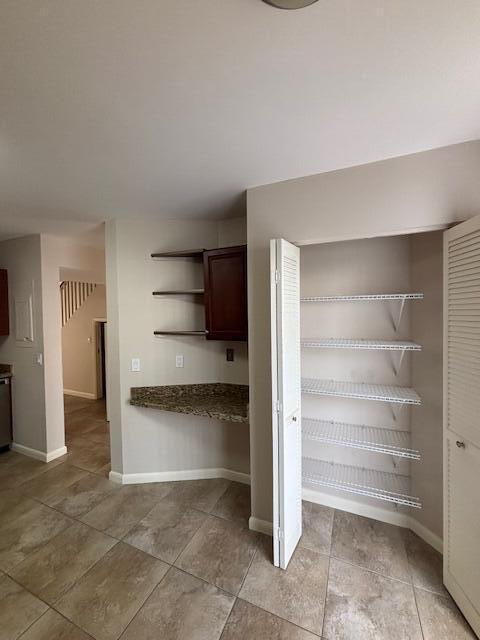 6191 Riverwalk Lane, Unit 4 Jupiter, FL 33458 - Photo 4 of 16 a view of a room with shelves on the wall