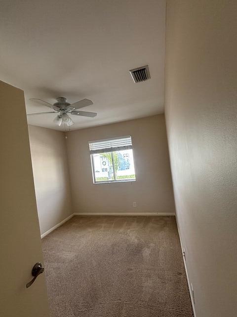 6191 Riverwalk Lane, Unit 4 Jupiter, FL 33458 - Photo 8 of 16 en empty room with windows and ceiling fan