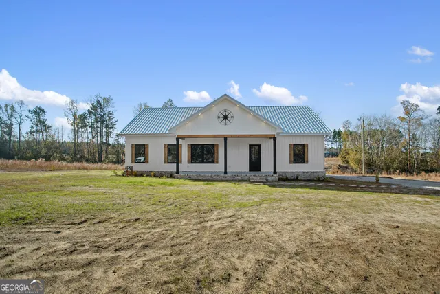 a large house with a big yard and large trees