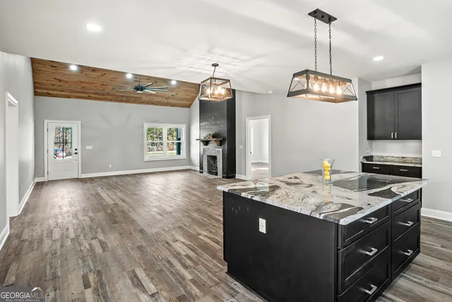 a kitchen with a sink cabinets and wooden floor