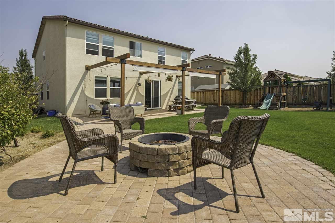 11305 Verazae Drive Reno, NV 89521 - Photo 1 of 25 a view of a patio with table and chairs potted plants with wooden floor and fence