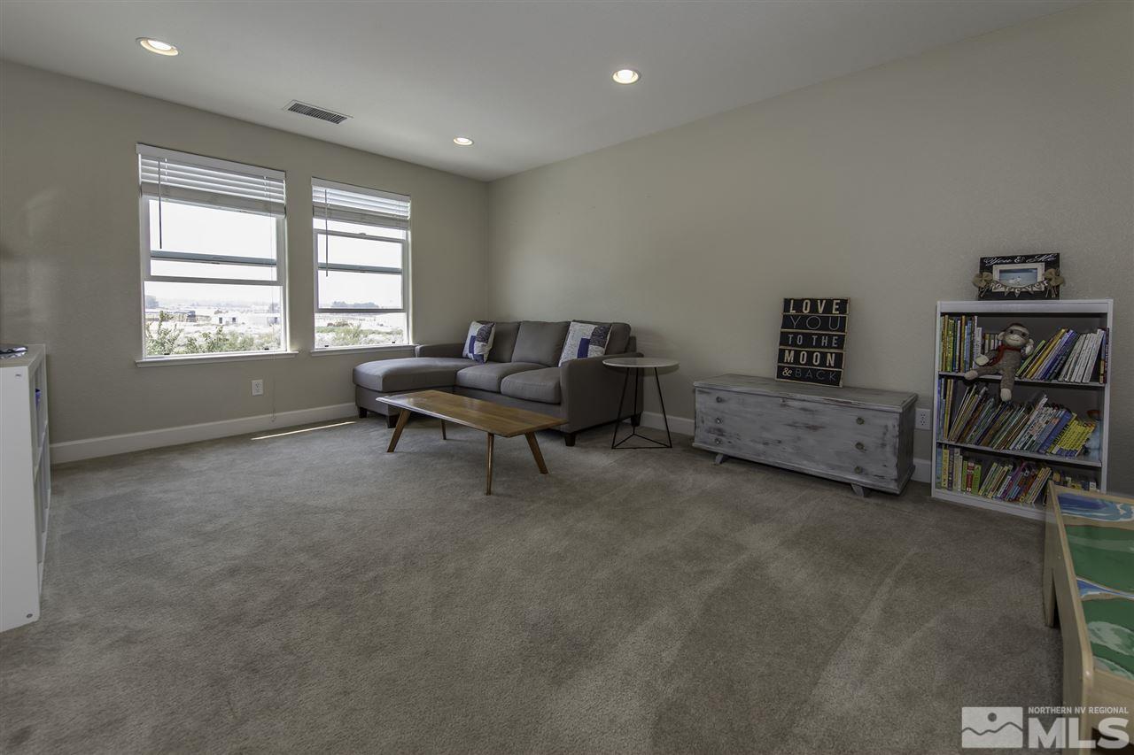 11305 Verazae Drive Reno, NV 89521 - Photo 17 of 25 a living room with furniture and a book shelf