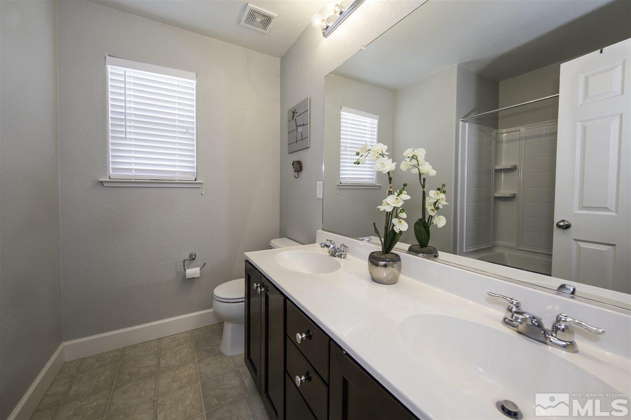 11305 Verazae Drive Reno, NV 89521 - Photo 20 of 25 a bathroom with a sink a vanity and a mirror