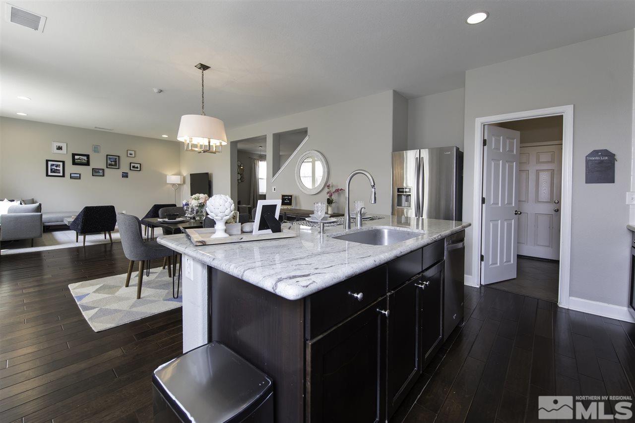 11305 Verazae Drive Reno, NV 89521 - Photo 8 of 25 a kitchen with a counter space dining table and chairs