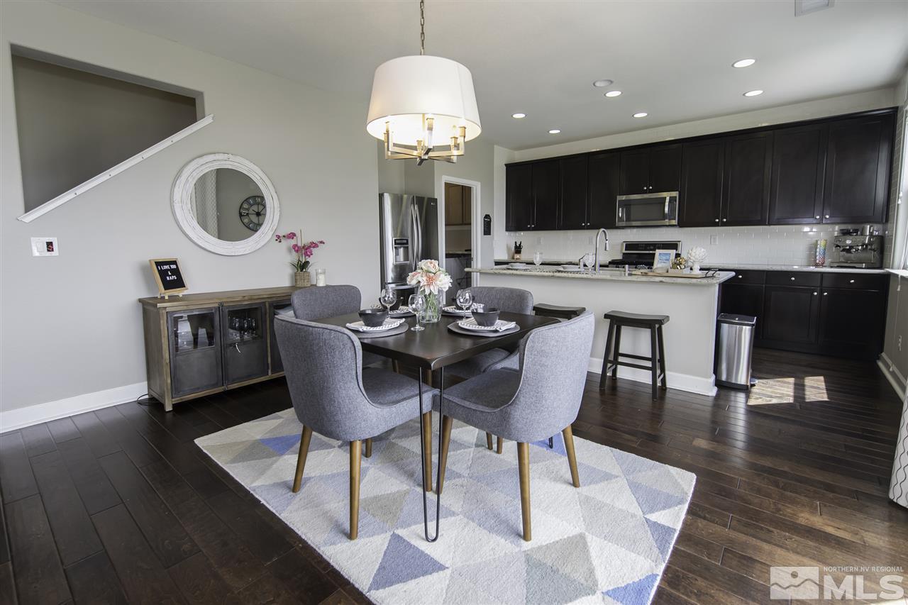 11305 Verazae Drive Reno, NV 89521 - Photo 10 of 25 a kitchen with a dining table chairs sink and stove