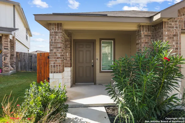 a view of house with backyard and sitting area