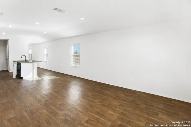 a view of a room with wooden floors