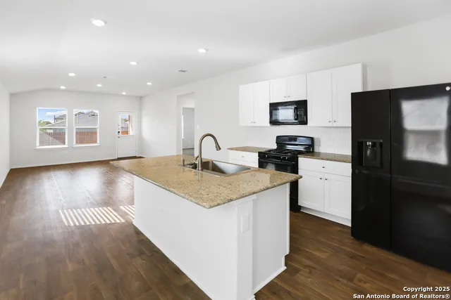 a kitchen with a sink and a refrigerator