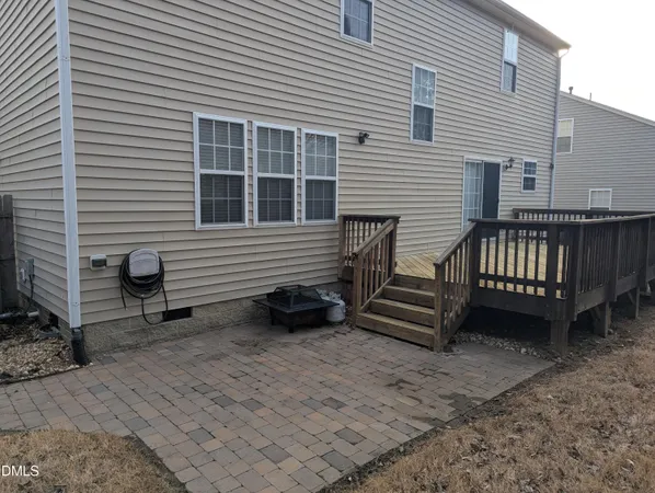 a view of a house with a yard and wooden fence