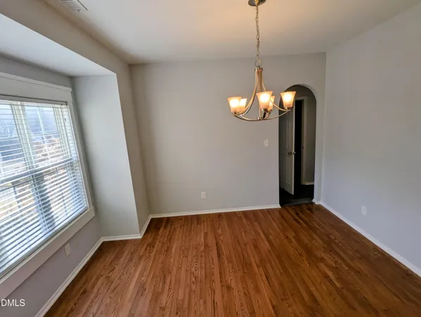 a view of a room with wooden floor and large windows