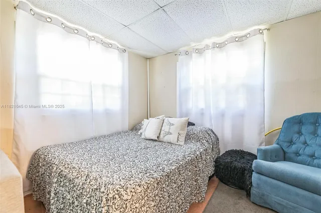 a bedroom with a bed couch and a window