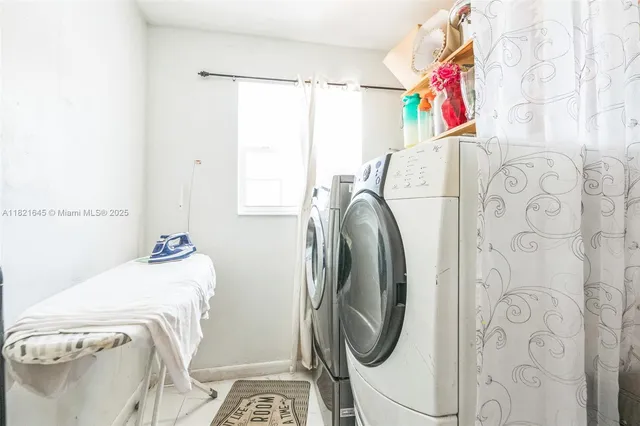 a utility room with a sink dryer and washer