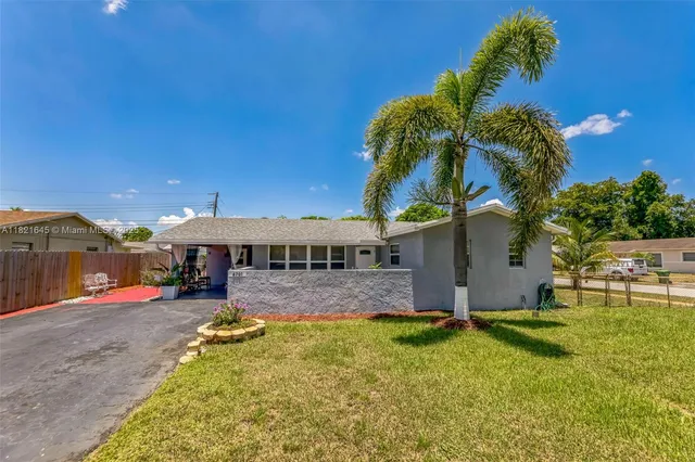 a view of a house with swimming pool and a yard