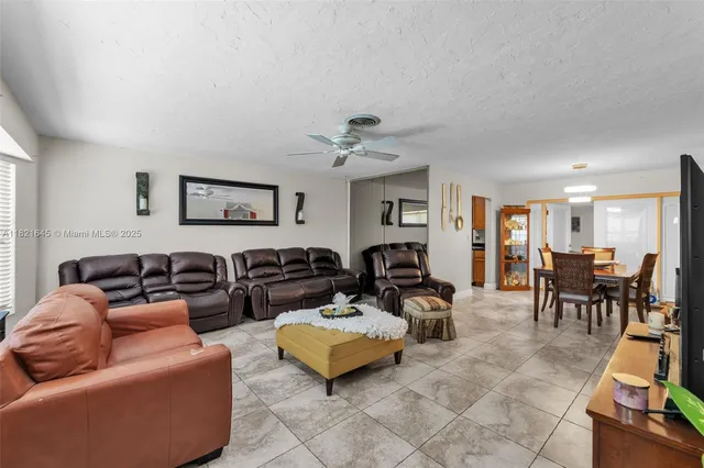 a living room with furniture a couch and a dining table