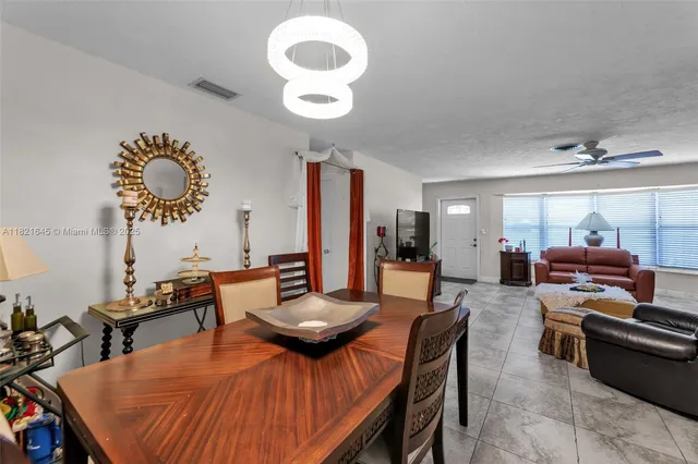 a view of a dining room and livingroom with furniture wooden floor and a rug