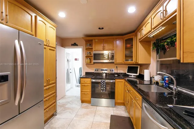 a kitchen with stainless steel appliances granite countertop a refrigerator stove and oven