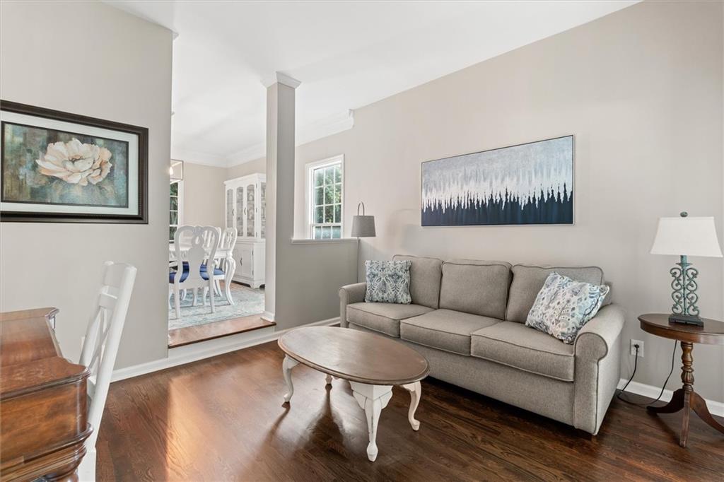326 Senators Ridge Drive Dallas, GA 30132 - Photo 6 of 37 a living room with furniture a wooden floor and a painting on the wall