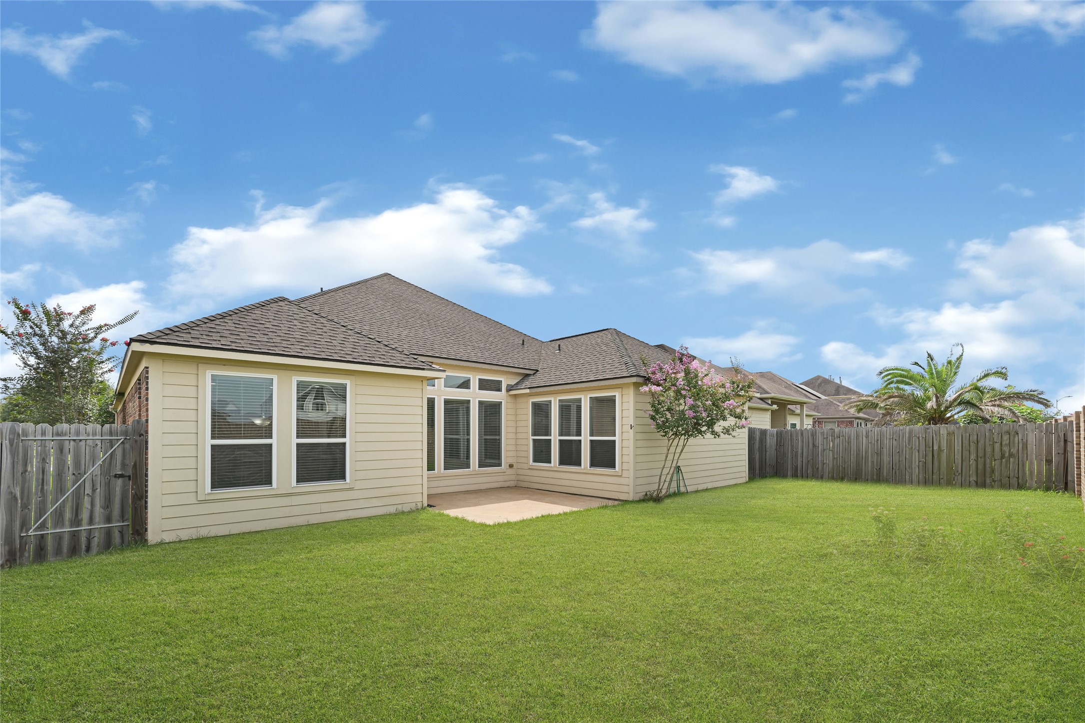 4702 Sedgewood Drive Rosenberg, TX 77471 - Photo 23 of 24 This home has a spacious backyard fenced-in privacy, and a patio area with large windows letting in natural lighitng. The setting is perfect for outdoor activities and relaxation.