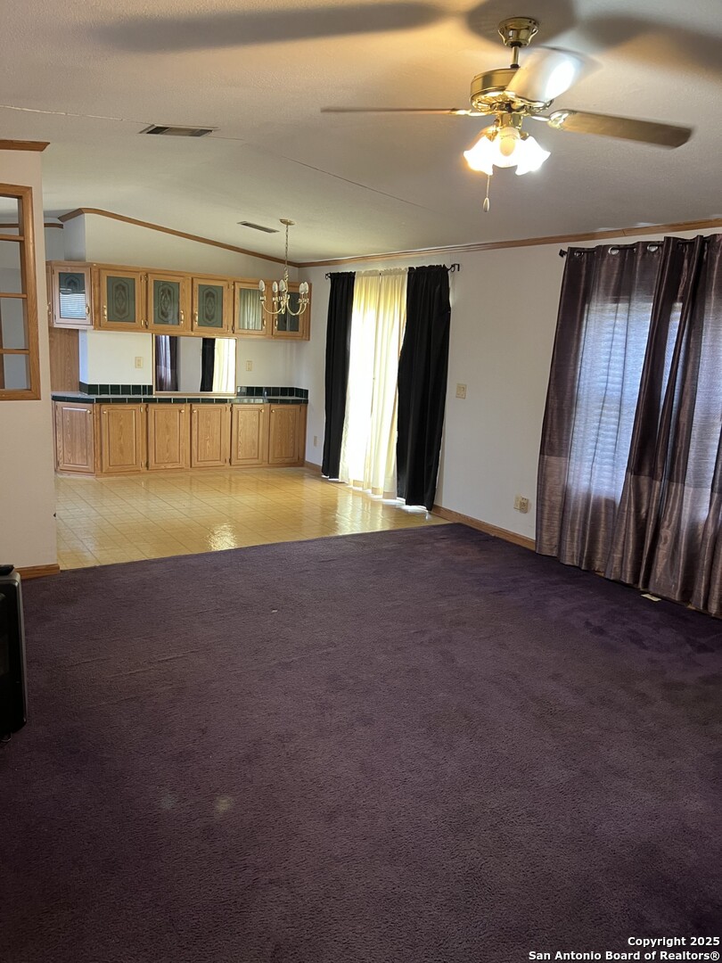 123 Chapman Street Pleasanton, TX 78064 - Photo 2 of 8 a view of an empty room with a fireplace