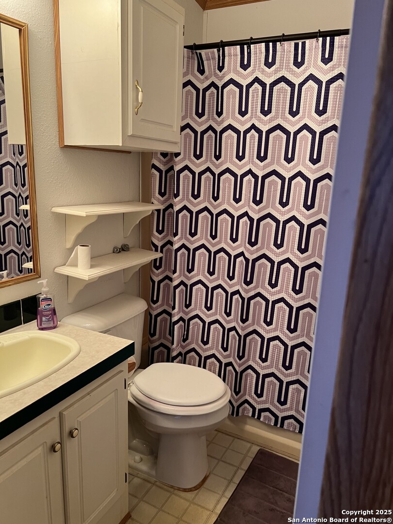 123 Chapman Street Pleasanton, TX 78064 - Photo 7 of 8 a bathroom with a toilet and a sink