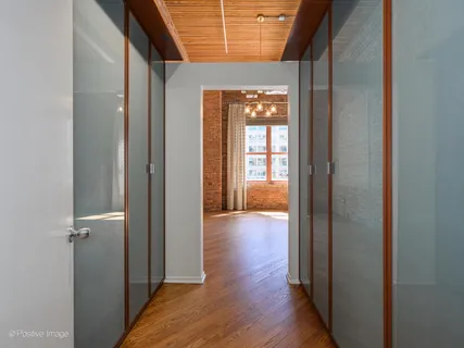 a view of hallway with wooden floor