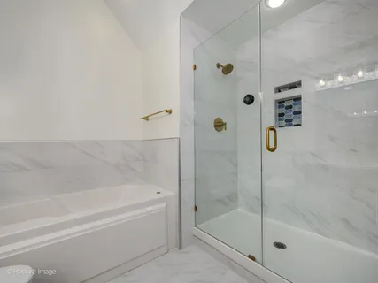 a bathroom with a bathtub and a shower