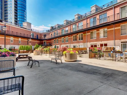 a view of a patio with a table and chairs and potted plants