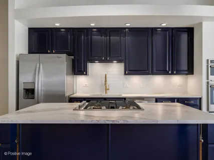 a kitchen with wooden cabinets and stainless steel appliances