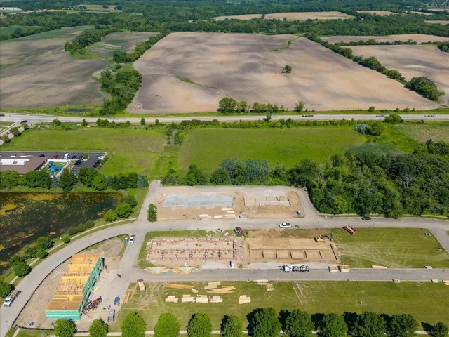 an aerial view of a residential houses with outdoor space and street view