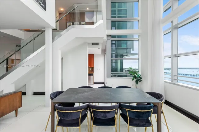 a balcony with table and chairs