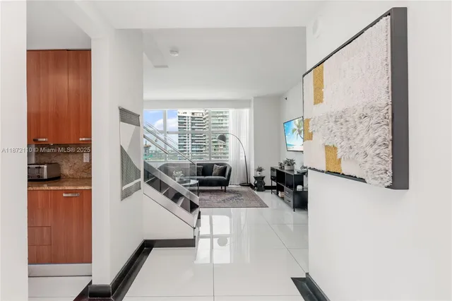 a view of a living room with furniture and a flat screen tv