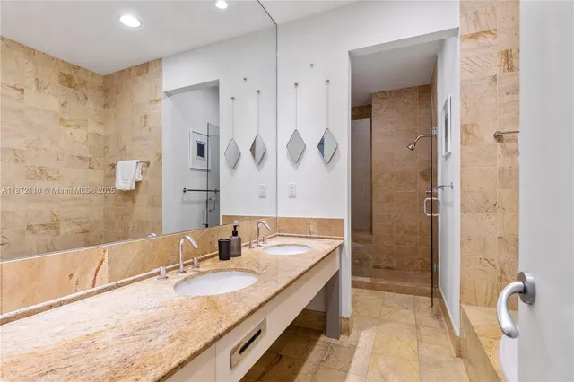 a bathroom with a granite countertop tub sink and shower