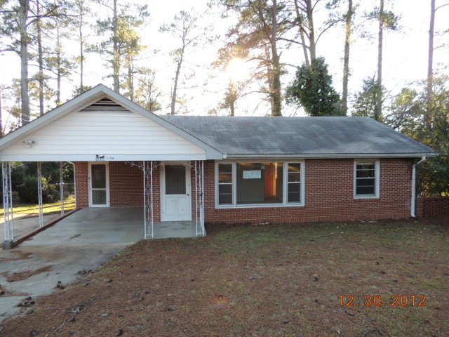 1752 Upper River Road Macon, GA 31211 - Photo 1 of 1 a front view of a house with a yard and garage