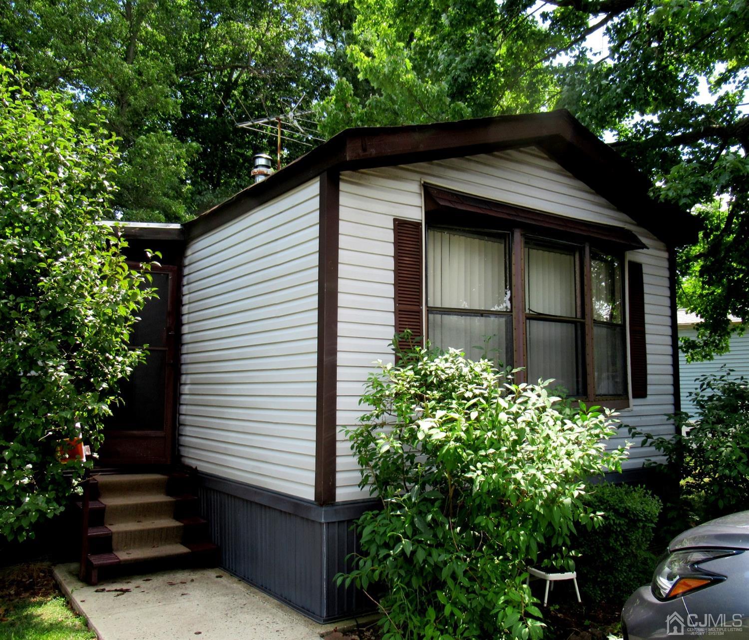 22 Emerson Road North Brunswick, NJ 08902 - Photo 1 of 14 a front view of a house with a garden