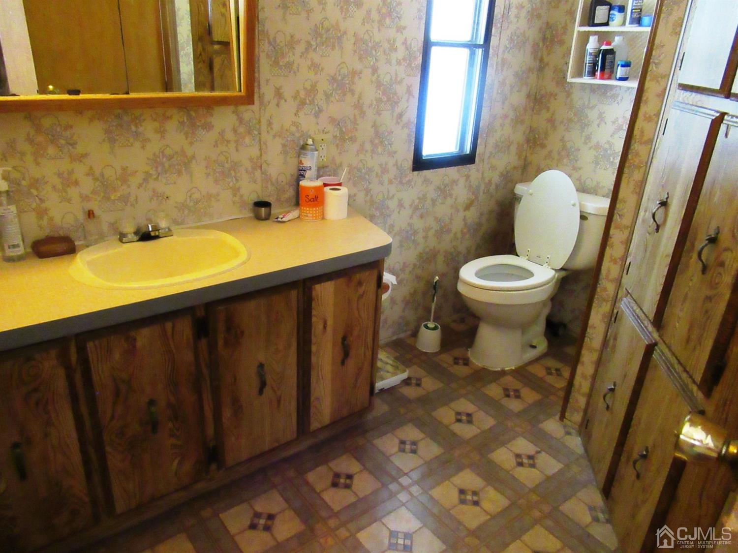 22 Emerson Road North Brunswick, NJ 08902 - Photo 11 of 14 a bathroom with a sink and a mirror