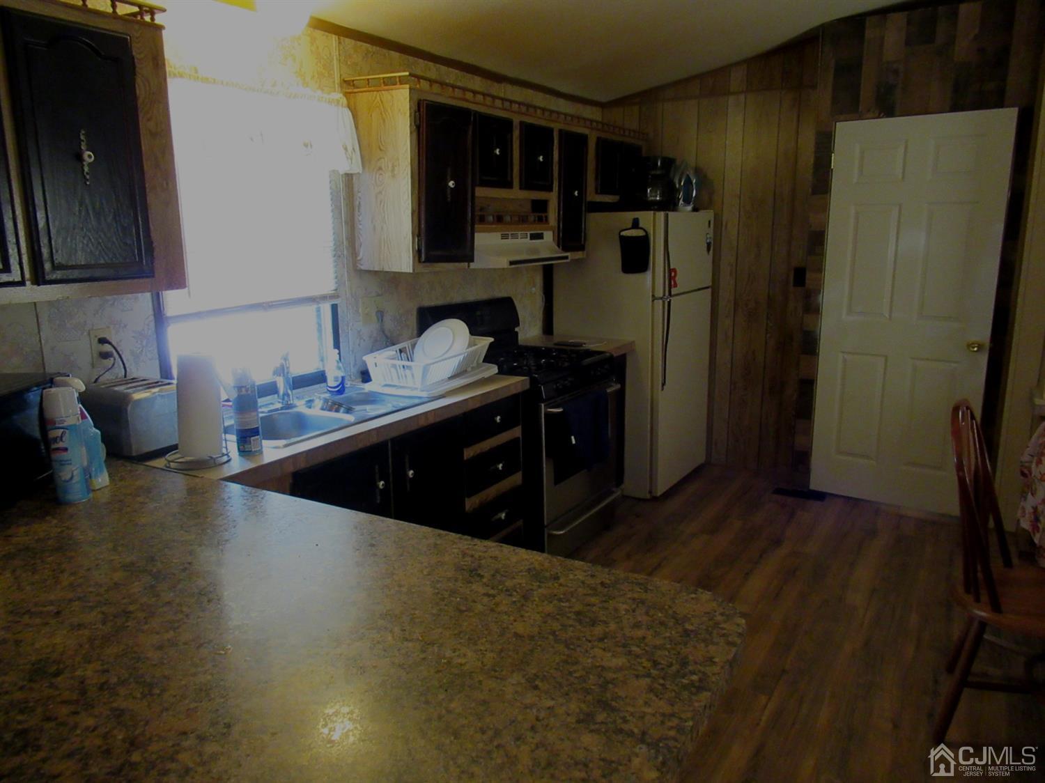 22 Emerson Road North Brunswick, NJ 08902 - Photo 8 of 14 a kitchen with stainless steel appliances granite countertop a refrigerator and a stove