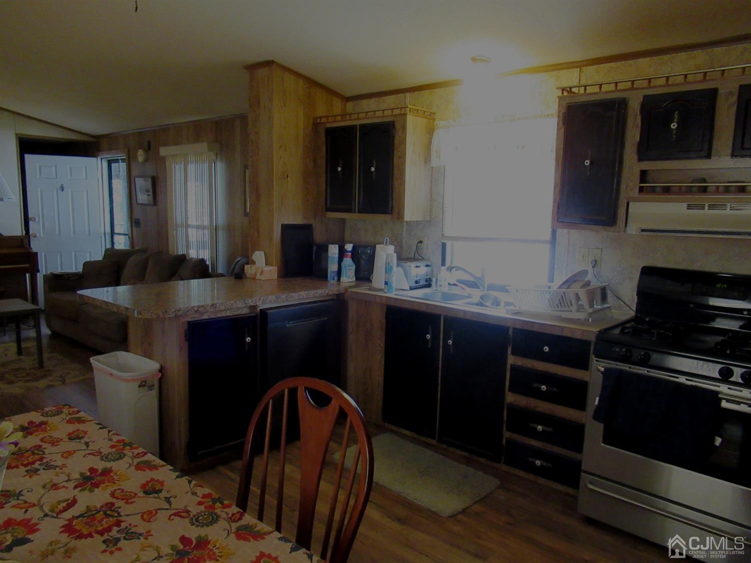 22 Emerson Road North Brunswick, NJ 08902 - Photo 9 of 14 a kitchen with a sink stove and cabinets