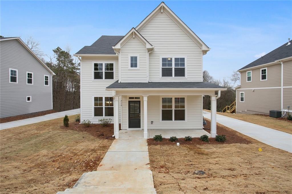 712 Scales Road Northwest Suwanee, GA 30024 - Photo 1 of 1 a front view of a house with a yard