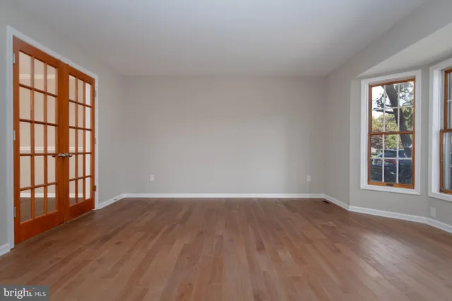 a room with a window and wooden floor