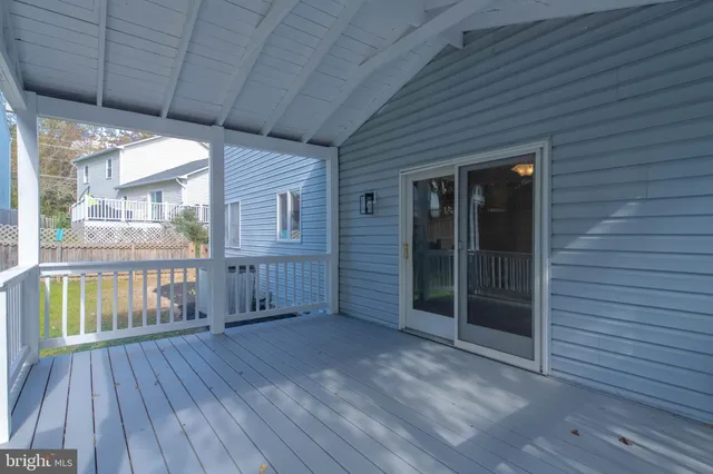 a view of front door deck house and wooden floor