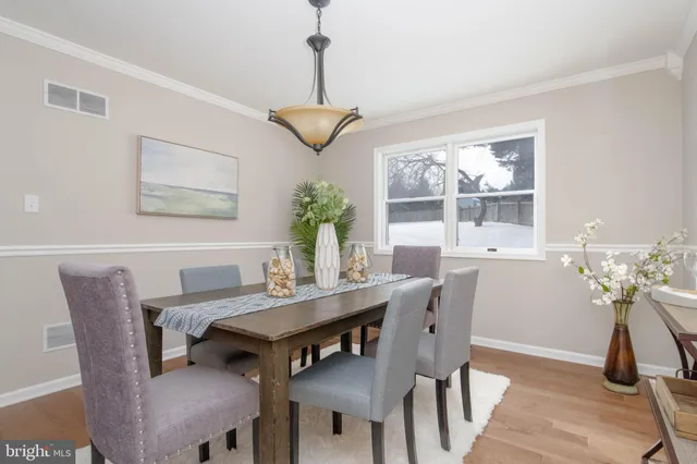 a view of a dining room with furniture wooden floor and a chandelier