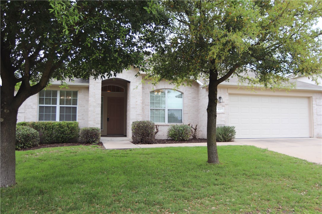 620 Busleigh Castle Way Pflugerville, TX 78660 - Photo 1 of 1 a front view of a house with garden